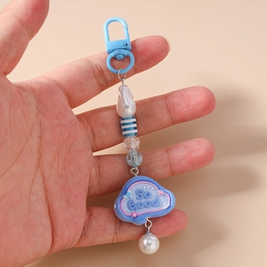Close-up of blue keychain with So Good cloud pendant, striped beads, and pearls