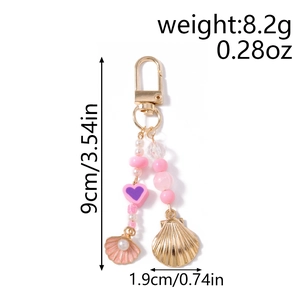 Detail of beaded keychain with pink shells and golden metal starfish charms