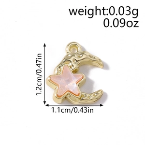 Detailed view of hammered gold star and moon pendant with pink shell inlay for DIY jewelry