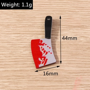 Detailed macro view of 44mm horror bloody cleaver charm with red splatter pattern