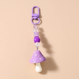 Close-up of purple mushroom charm with striped beads and a durable metal D-ring clasp