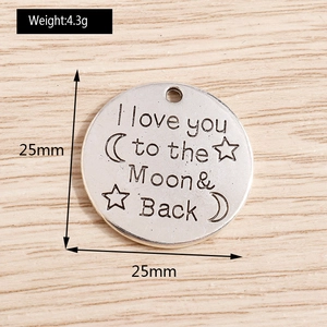 Detailed view of engraved silver moon and stars charm with 25mm diameter and 4.3g weight
