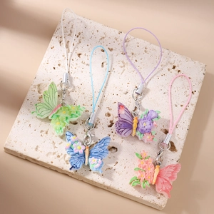 Detailed set of four butterfly phone charms with 3D flowers in green, blue, purple, and pink