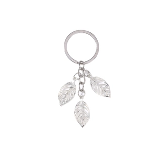 Minimalist silver leaf pendant keychain with hollow tree leaf charms on white background
