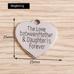 Macro view of 25mm heart pendant with mother-daughter engraving and dimensions