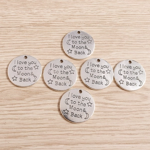 Macro detail of six vintage silver moon pendants with I love you to the Moon & Back engraving