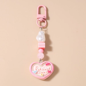 Detail of pink Forever Love heart pendant with striped beads and pearl keychain