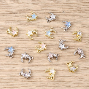 Flat lay of star and moon charms with colorful synthetic opal inlays on wood