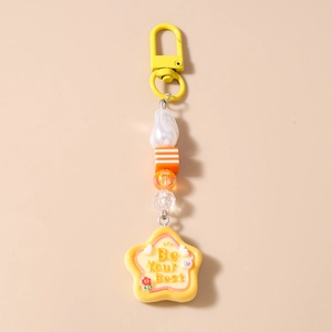Detail of beaded keychain with colorful stripes, pearl, and Be Your Best star charm