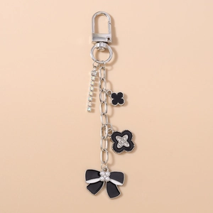 Detailed keychain with black enamel floral charms, tassel pearls and sparkling rhinestones