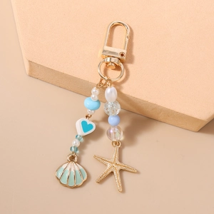 Detail of nautical keychain with starfish, seashell pendants and imitation pearls