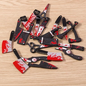 Macro detail of scary blood-stained mini knives for Halloween DIY jewelry making