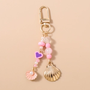 Detailed view of beaded keychain with pink shells, purple heart, and gold alloy clasp