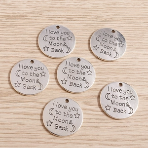 Silver round metal charms with I love you to the Moon and Back engraving for DIY jewelry