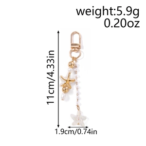 Detail of starfish and pearl keychain showing golden hardware and product dimensions
