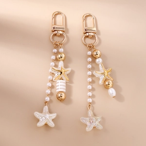 Golden starfish and pearl keychain pendants for bags featuring elegant striped beads
