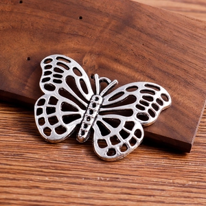 Detaillierte Makroansicht eines antiken silbernen Schmetterlingsanhängers für DIY-Schmuck