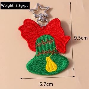 Detail view of woven Christmas key ring with red bell embroidery and star clasp