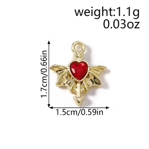 Macro detail of a golden heart pendant with red stone and dimensions 1.7cm by 1.5cm