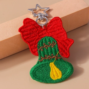 Christmas embroidered keychain with red bow and green bell on a silver star clasp