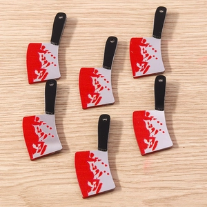 Close-up of DIY acrylic mini bloody cleaver charms for Halloween jewelry making