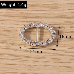 Detail view of silver oval rhinestone connector charm measuring 21mm by 16mm