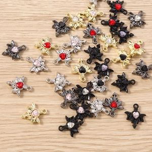 Detailed macro view of heart wing pendants with colorful gemstones for DIY jewelry crafts