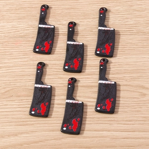 Detailed view of blood-stained cleaver charms for DIY Halloween jewelry projects