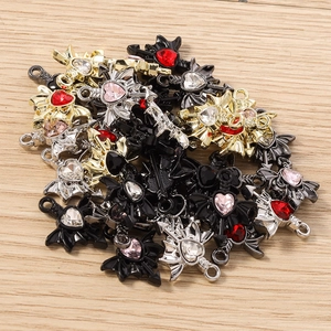 Macro detail of gothic heart wing pendants with colorful rhinestones for DIY jewelry making