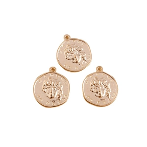 Three vintage round gold coin pendants with embossed head relief and polished metal finish
