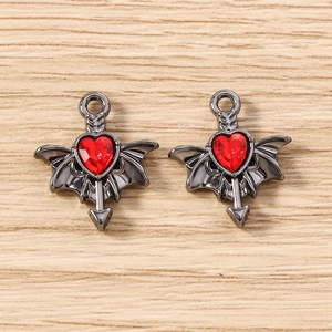 Detailed view of Gothic bat wing heart pendants with red faceted gems and cupid arrows