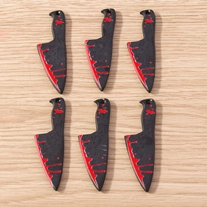 Detail of horror style mini cleaver charms with red blood splatter for DIY Halloween jewelry