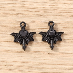 Detail view of black gothic bat wing heart charms with arrow for DIY jewelry crafting