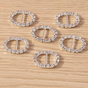 Detailed view of silver oval rhinestone buckles with alloy base and crystal inlay