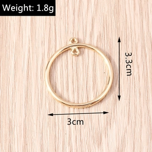 Detailed view of a 3.3cm gold geometric circular pendant with dual loops for jewelry making