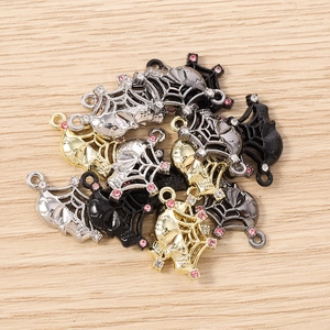 Detail showing Gothic skull and spider web charms with sparkling rhinestones for DIY jewelry