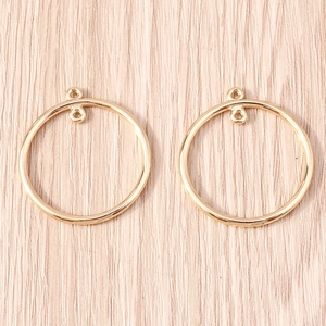 Close-up of golden geometric circle connectors for DIY jewelry making and earrings