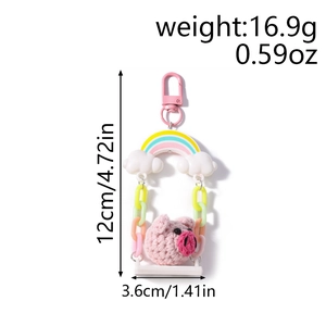 Pink crochet pig on swing keychain with rainbow detail and size measurements