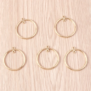 Five gold-plated geometric circle charms with double hanging loops for DIY jewelry projects
