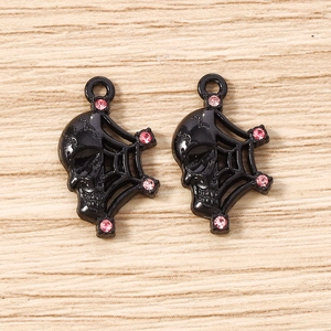 Detailed macro view of black skull spider web pendants with pink rhinestone accents