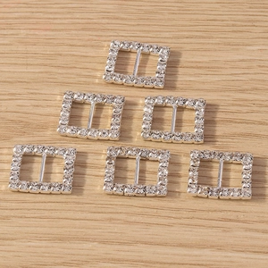 Macro view of six silver rectangular rhinestone buckles for DIY fashion accessory design
