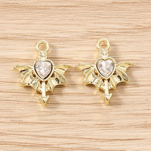 Detailed view of gold-plated winged heart charms with crystal inlay for DIY jewelry