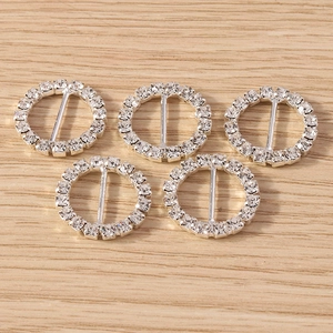 Close-up of five round rhinestone ribbon sliders in silver finish for DIY wedding decor