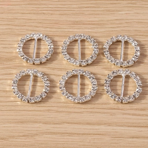 Detail of six silver round rhinestone buckles with center bar for DIY crafts