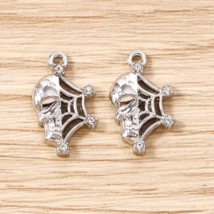 Close-up of silver skull spider web pendants with sparkling rhinestones for jewelry making