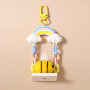Detail of wool felt bee keychain with rainbow swing and colorful plastic chain on yellow base