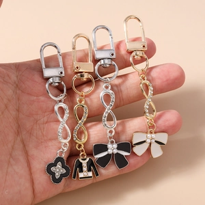 Fashionable rhinestone infinity keychain set with floral and bow charms for women