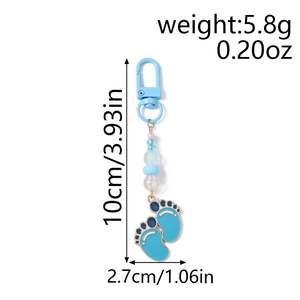 Detail view of blue baby footprint keychain with beads and dimension labels