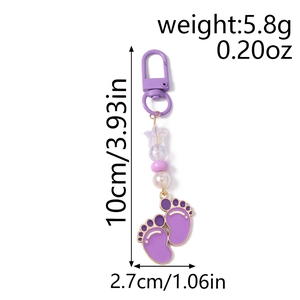 Detailed view of purple paw print keychain with star beads and dimension labels