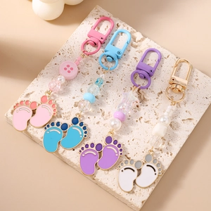 Baby footprint keychains with colorful beads and metal lobster clasps in four pastel colors